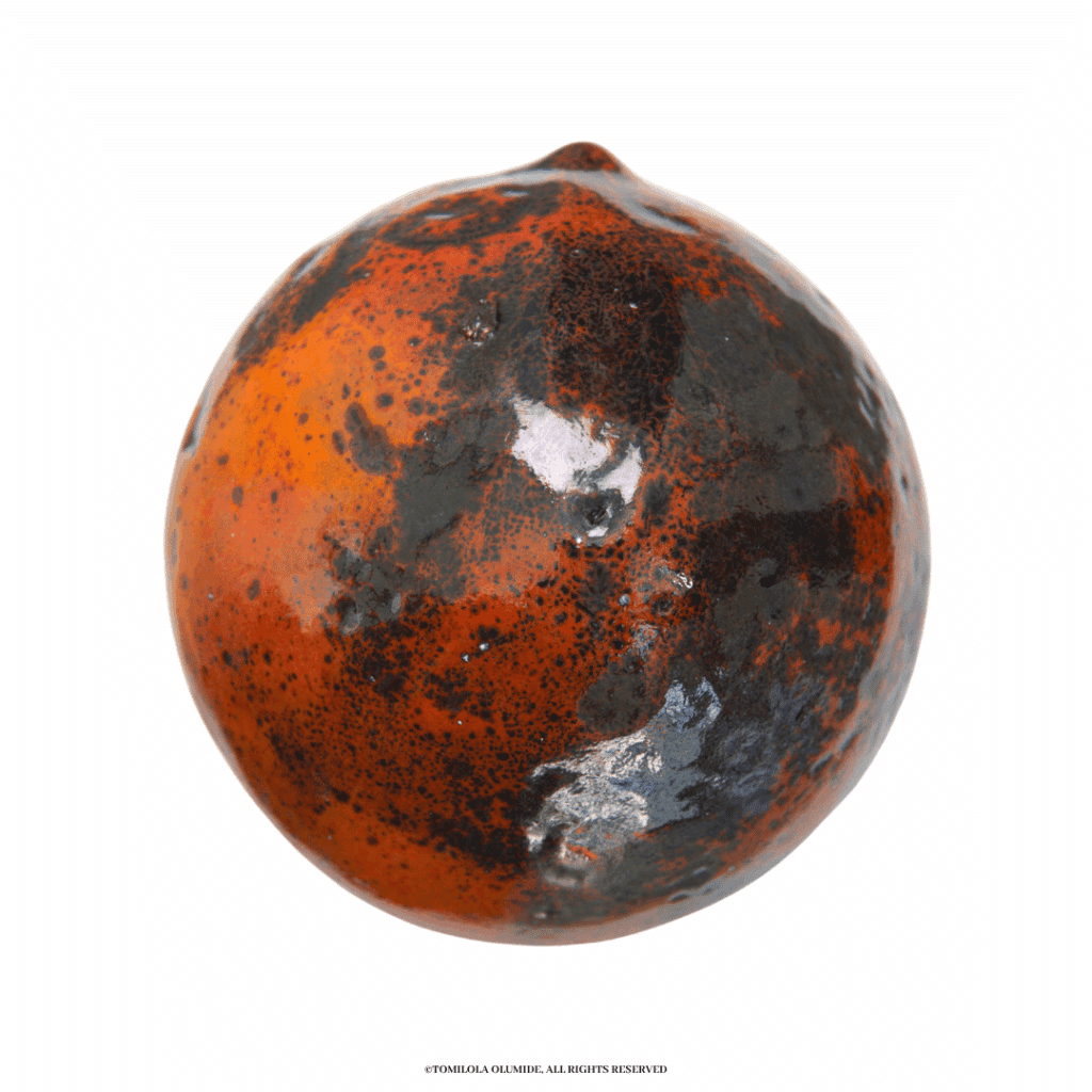 Agbalumo fruit, Ìnù mí dùn | 2025 Sculpture (kiln-fired enamel glass on silversmithed copper metal), 36.4 x 35.8cm ​​​​​​by Artist Tomilola Olumide